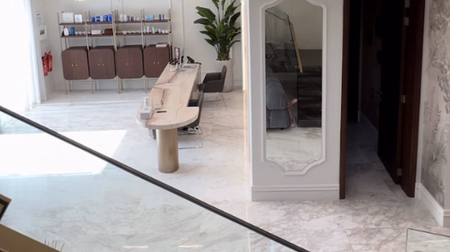 Brow & Beauty salon corridor with glazed rooms and upholstered waiting chairs