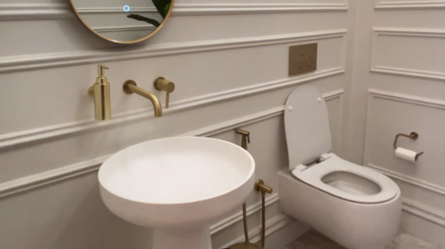 Brow & Beauty washroom with a round basin, gold fittings and wall mouldings