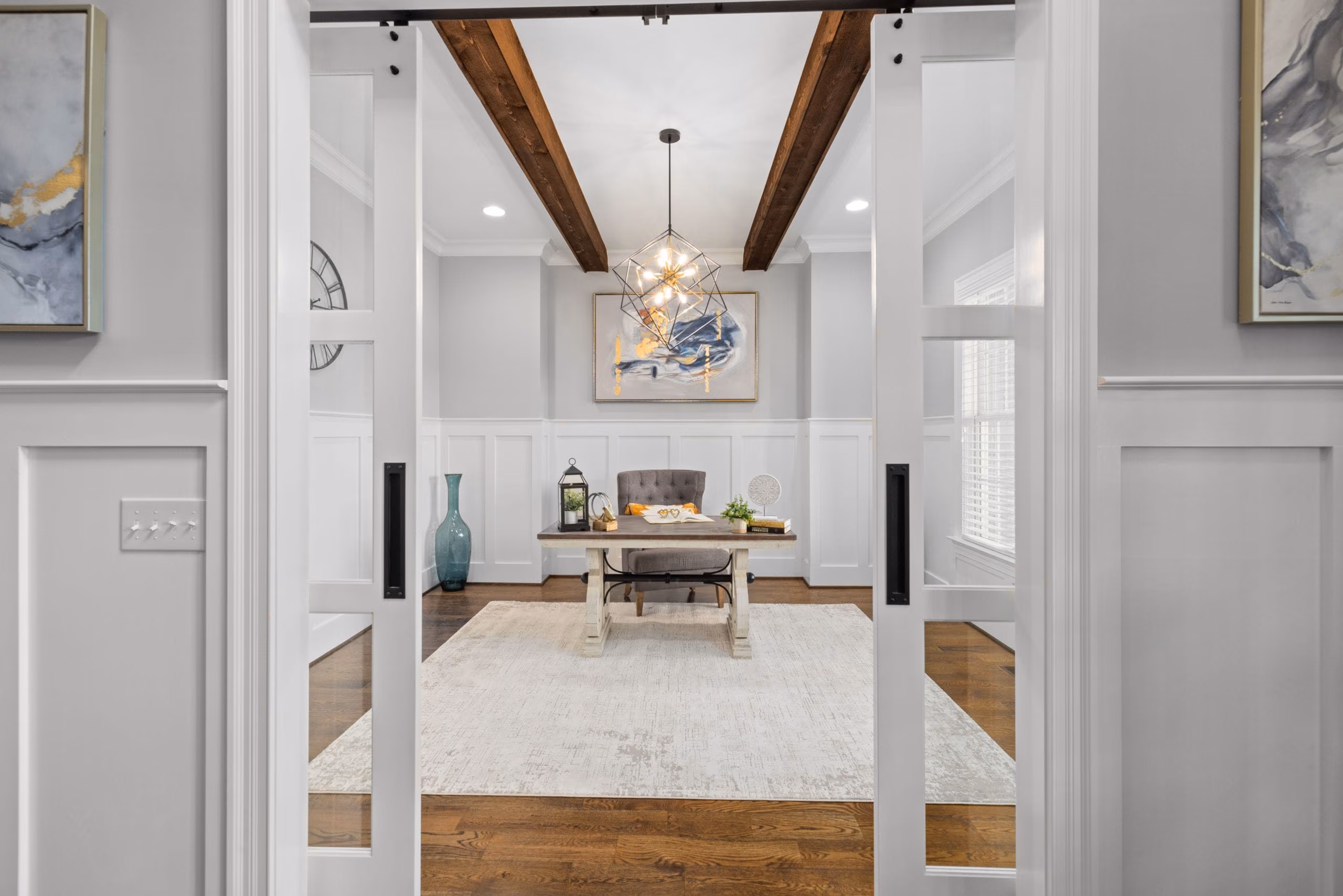 White glazed sliding doors opening onto a bright study, with a neat light switch beside them