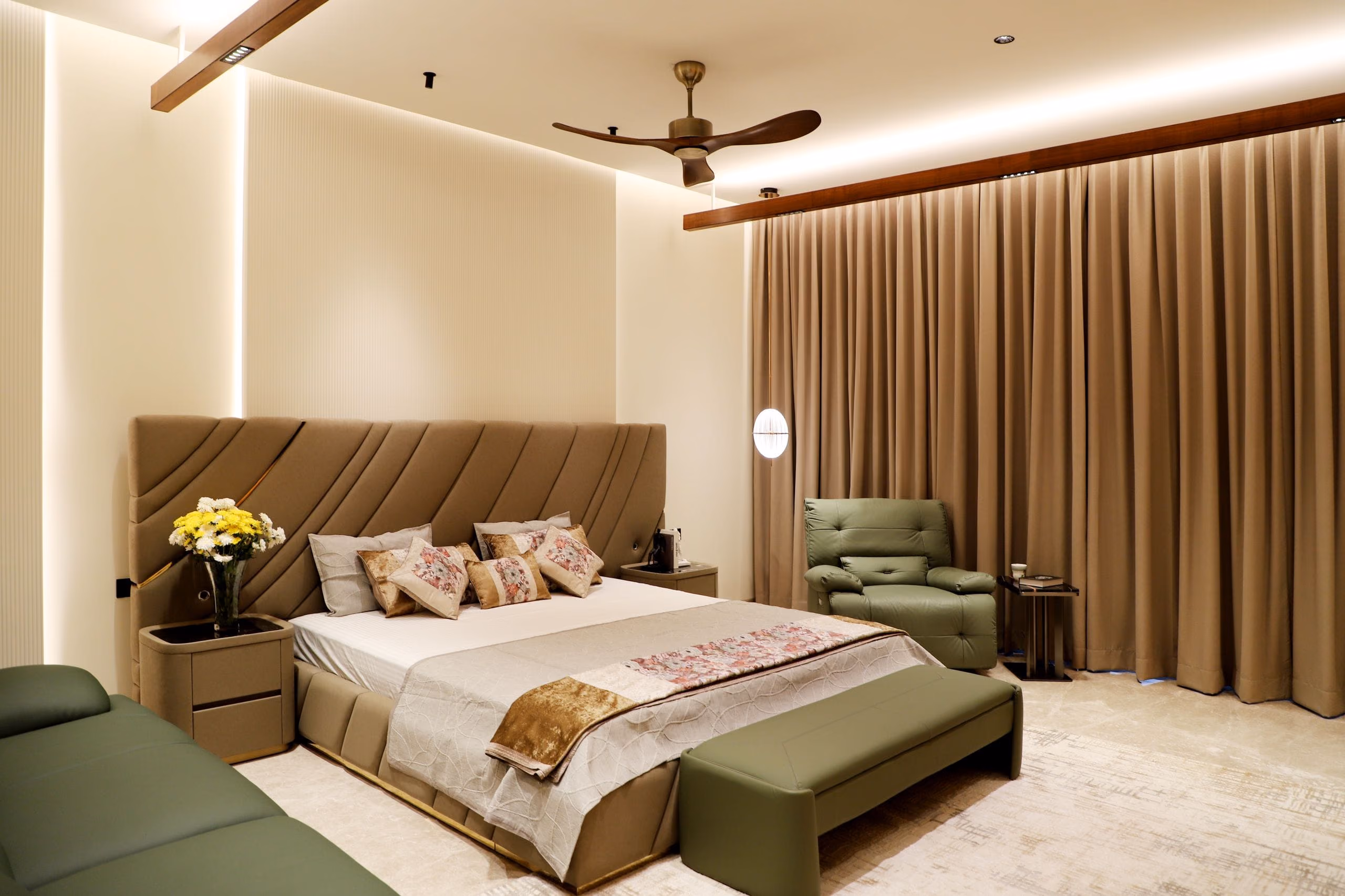 Bedroom with recessed curtain track, cove lighting, padded headboard and soft neutral palette